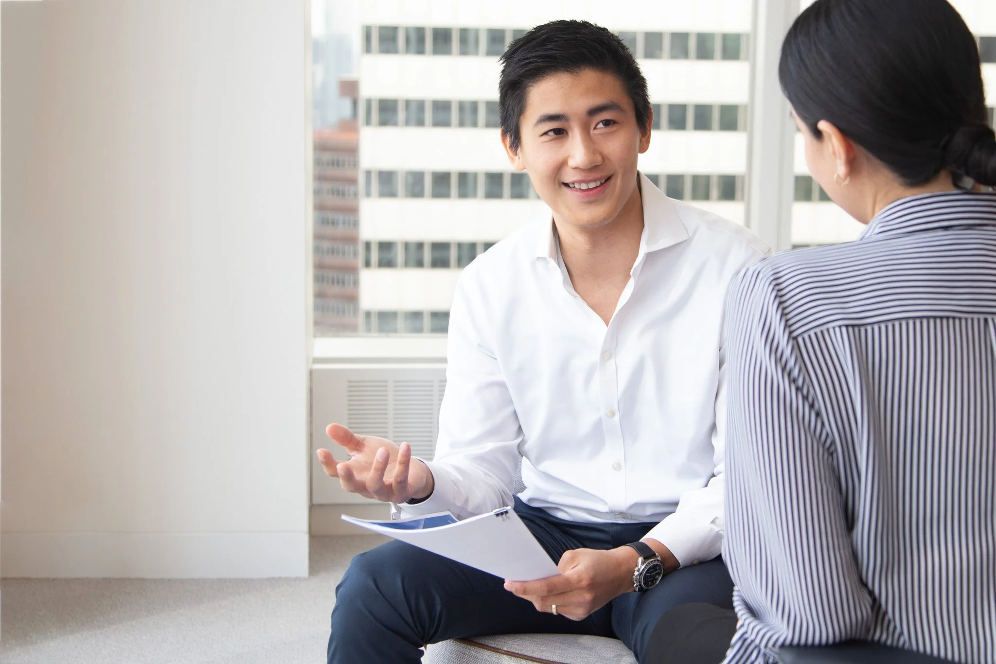 Two colleagues talking in a bright office